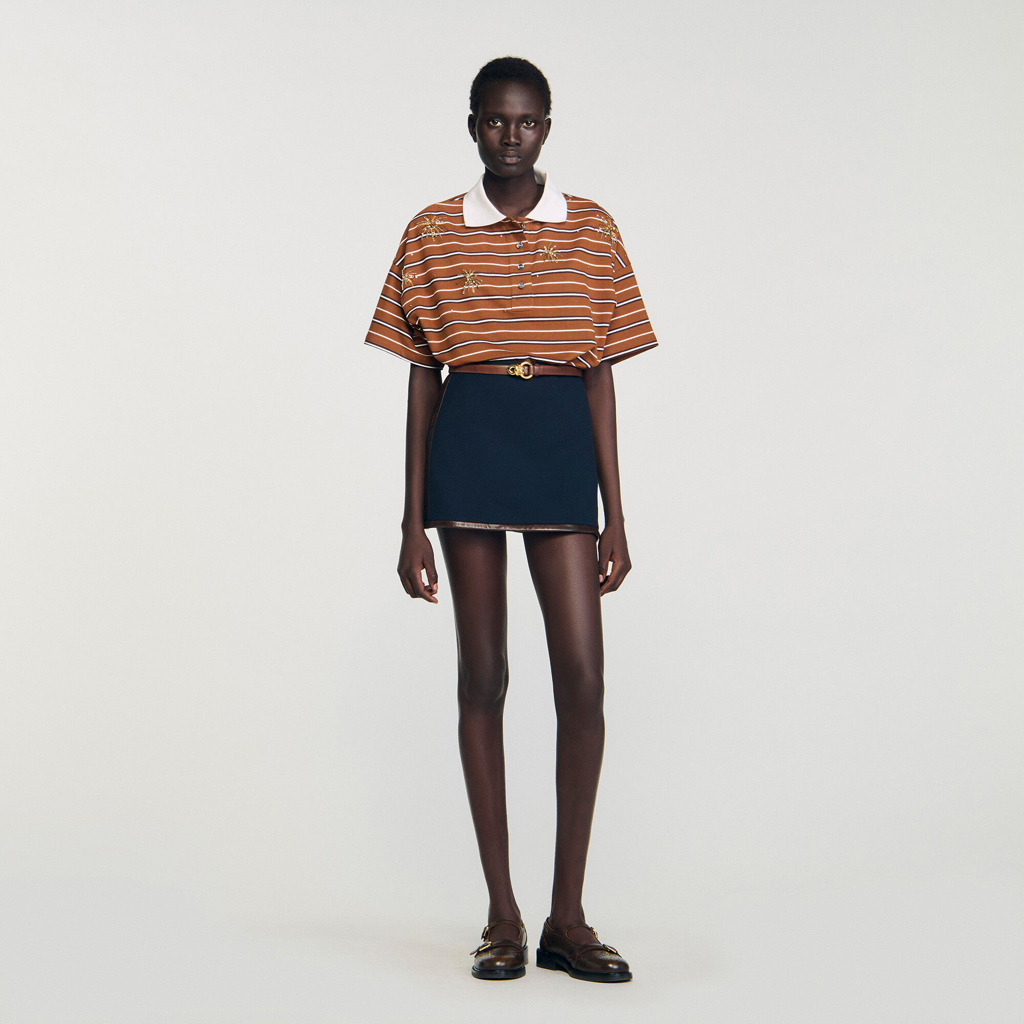 Short skirt with leather bands