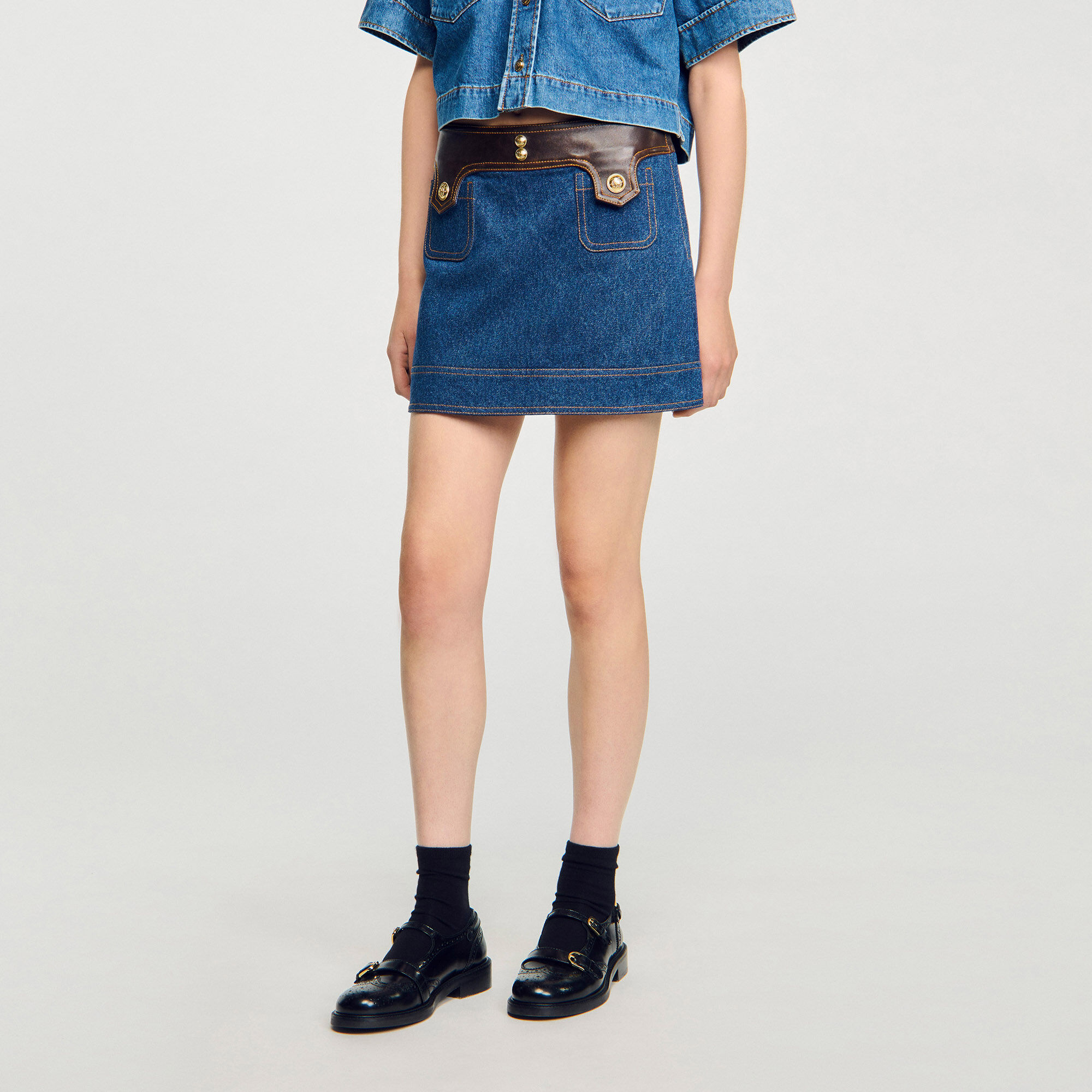 Short denim and leather skirt