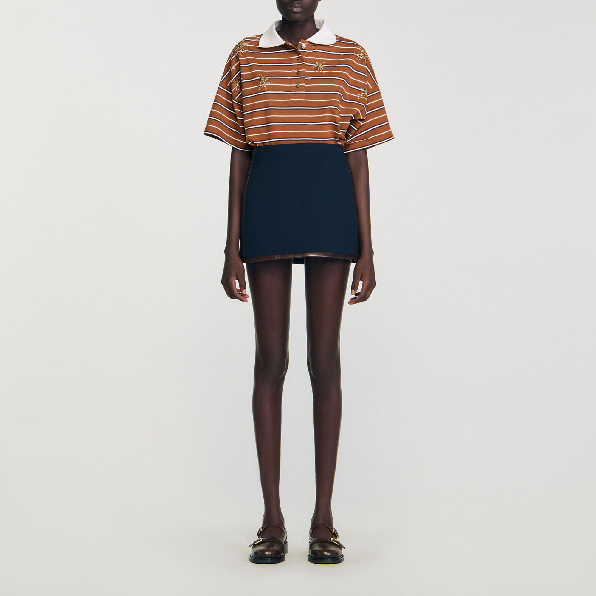 Short skirt with leather bands - Women | Sandro